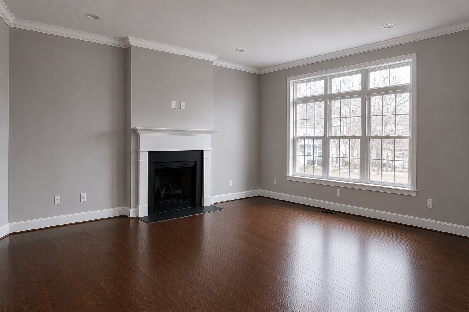 Empty living room with fireplace and hardwood floors before virtual staging